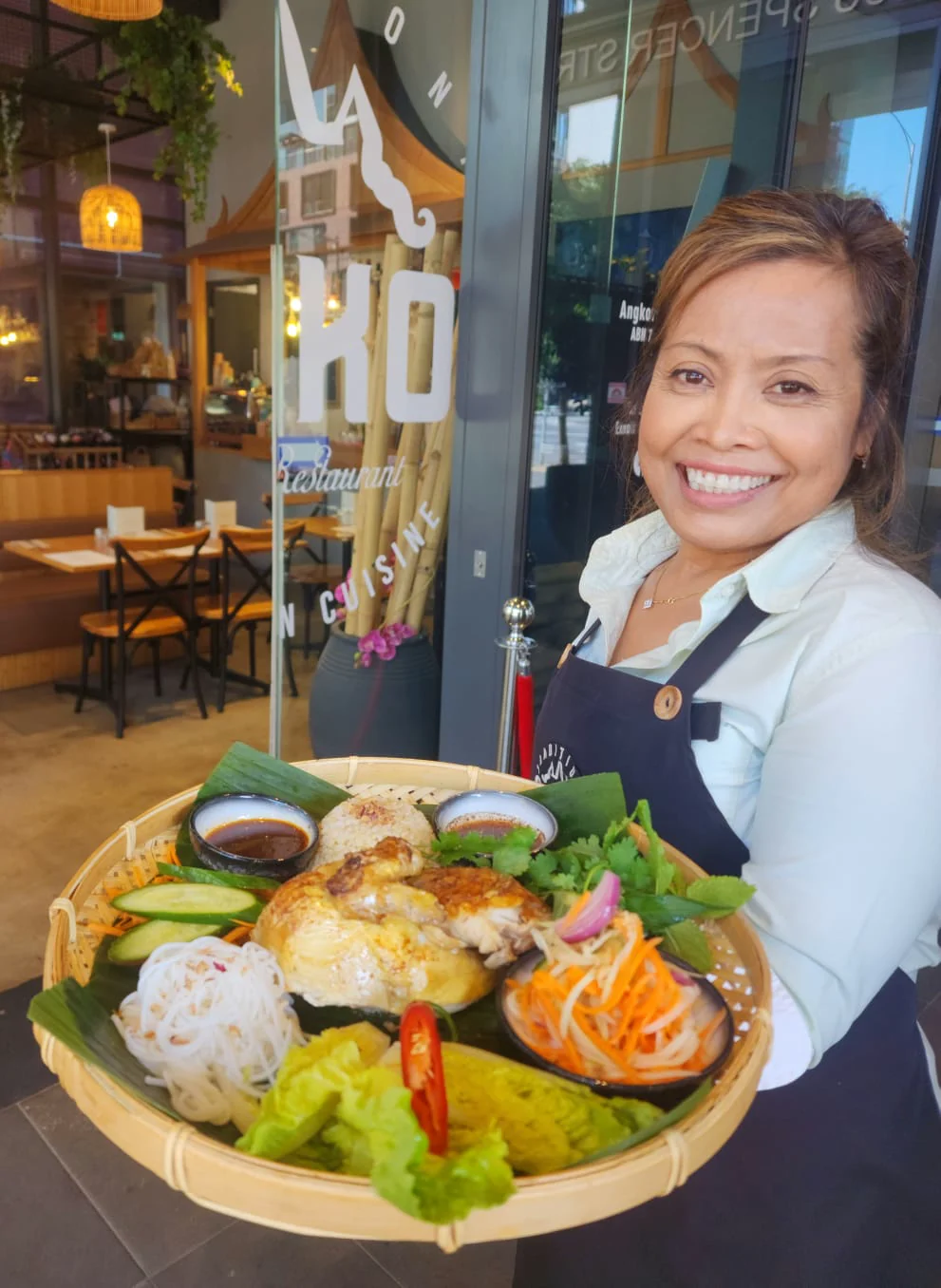 Chef Neri presenting a Cambodian sharing platter at the entrance to ANGKOR Cambodian Flavours